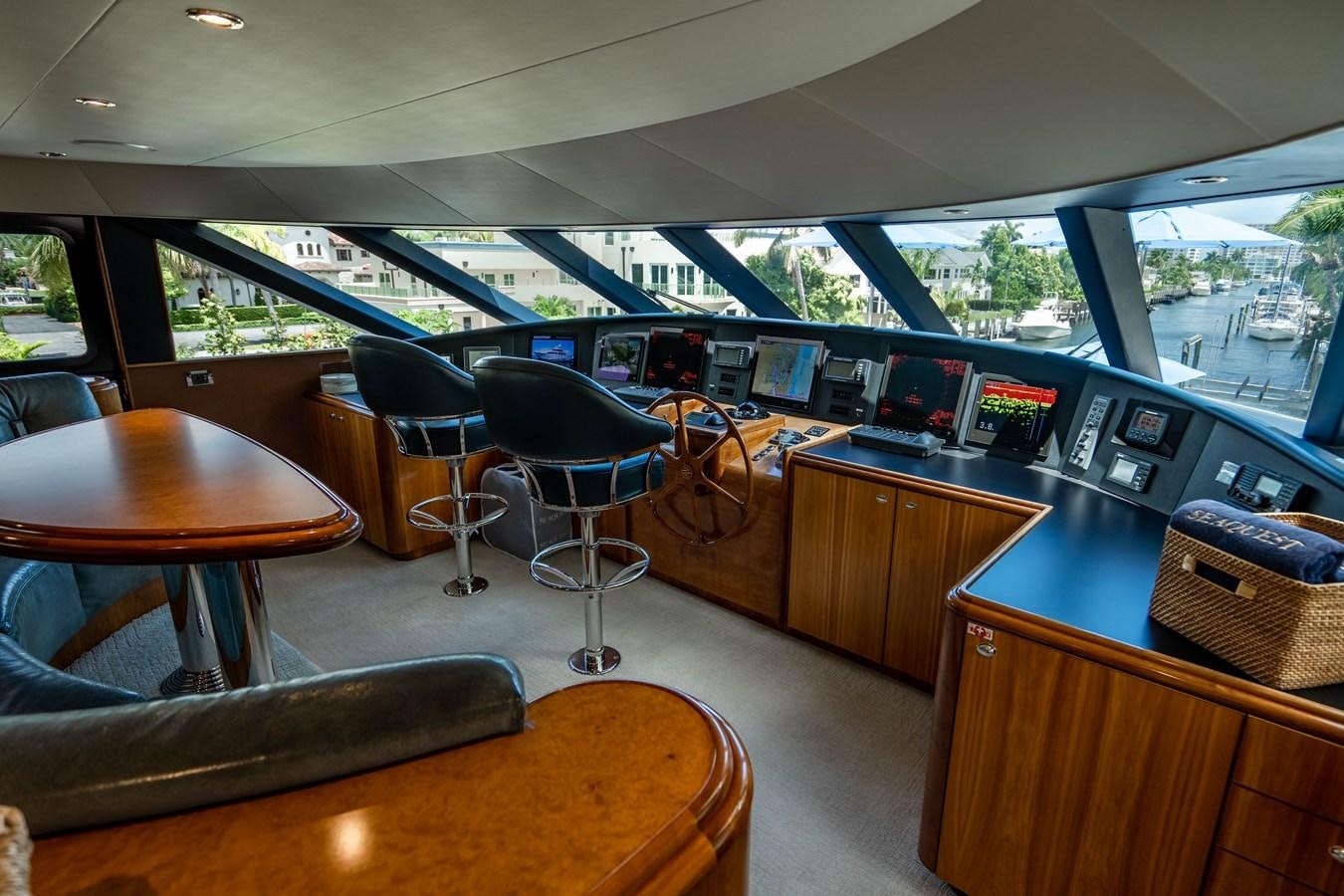 a room with a table and chairs aboard YOLO Yacht for Sale