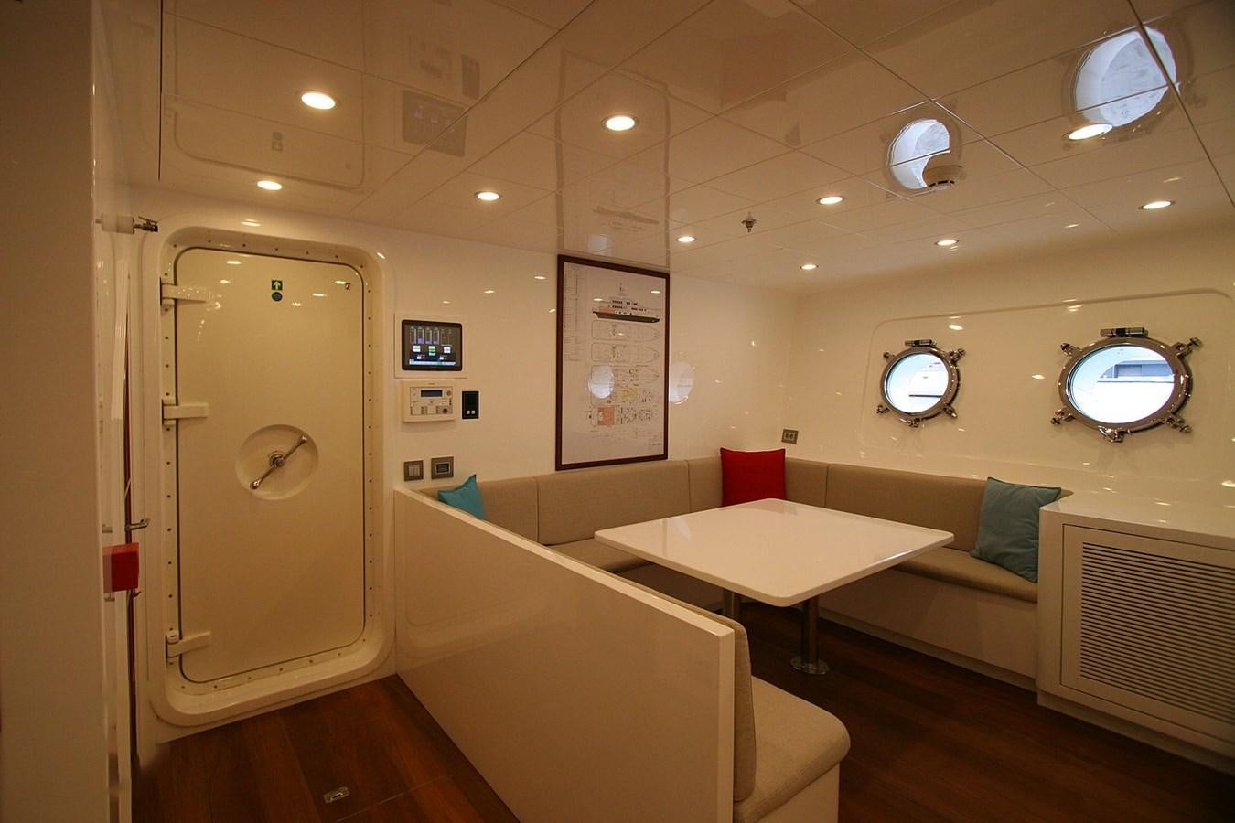 a room with a table and chairs aboard METEOR Yacht for Sale