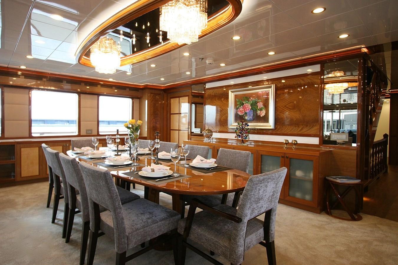 a restaurant with a table and chairs aboard METEOR Yacht for Sale