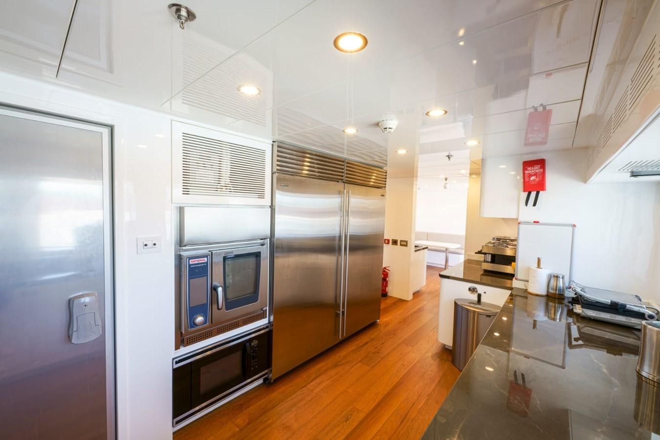 a large kitchen with stainless steel appliances aboard METEOR Yacht for Sale