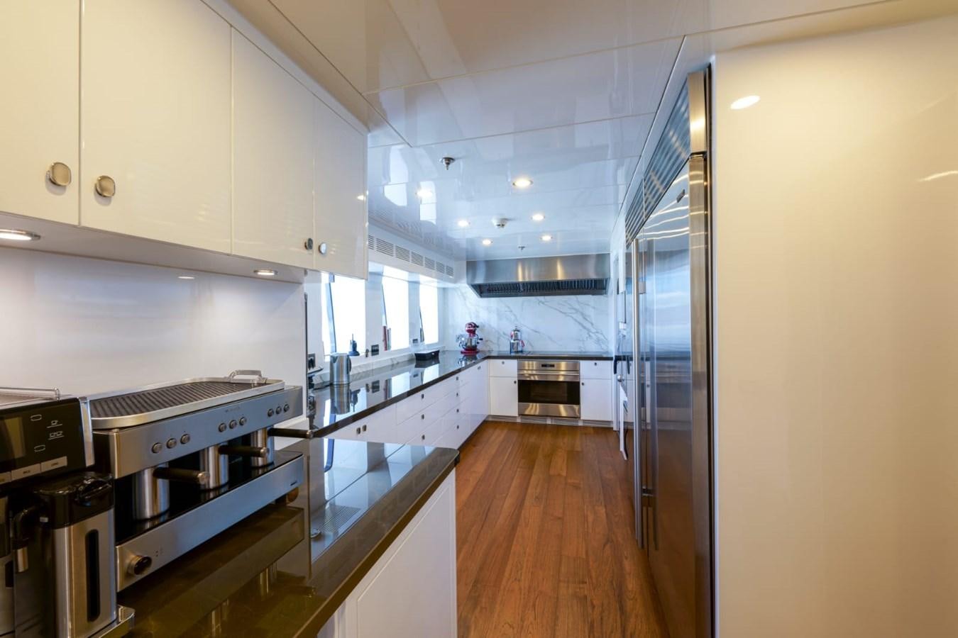 a kitchen with a large island aboard METEOR Yacht for Sale
