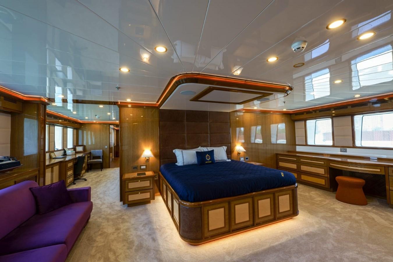 a large room with a bed and a desk aboard METEOR Yacht for Sale
