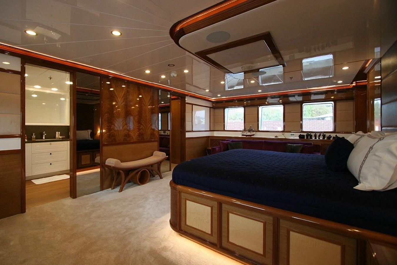 a bedroom with a bed and a desk aboard METEOR Yacht for Sale