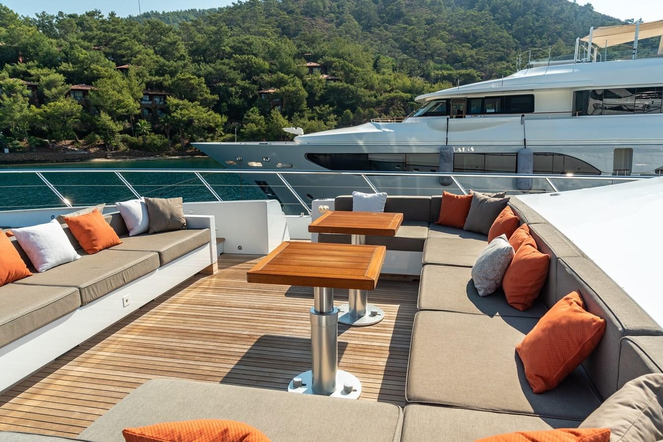 a living room with a deck overlooking a body of water aboard ASYA Yacht for Sale