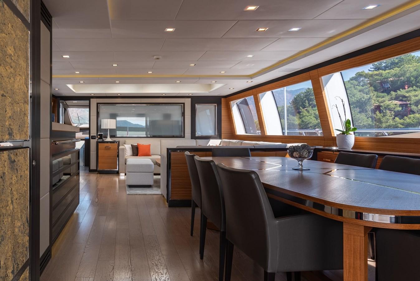 a large room with a table and chairs aboard ASYA Yacht for Sale