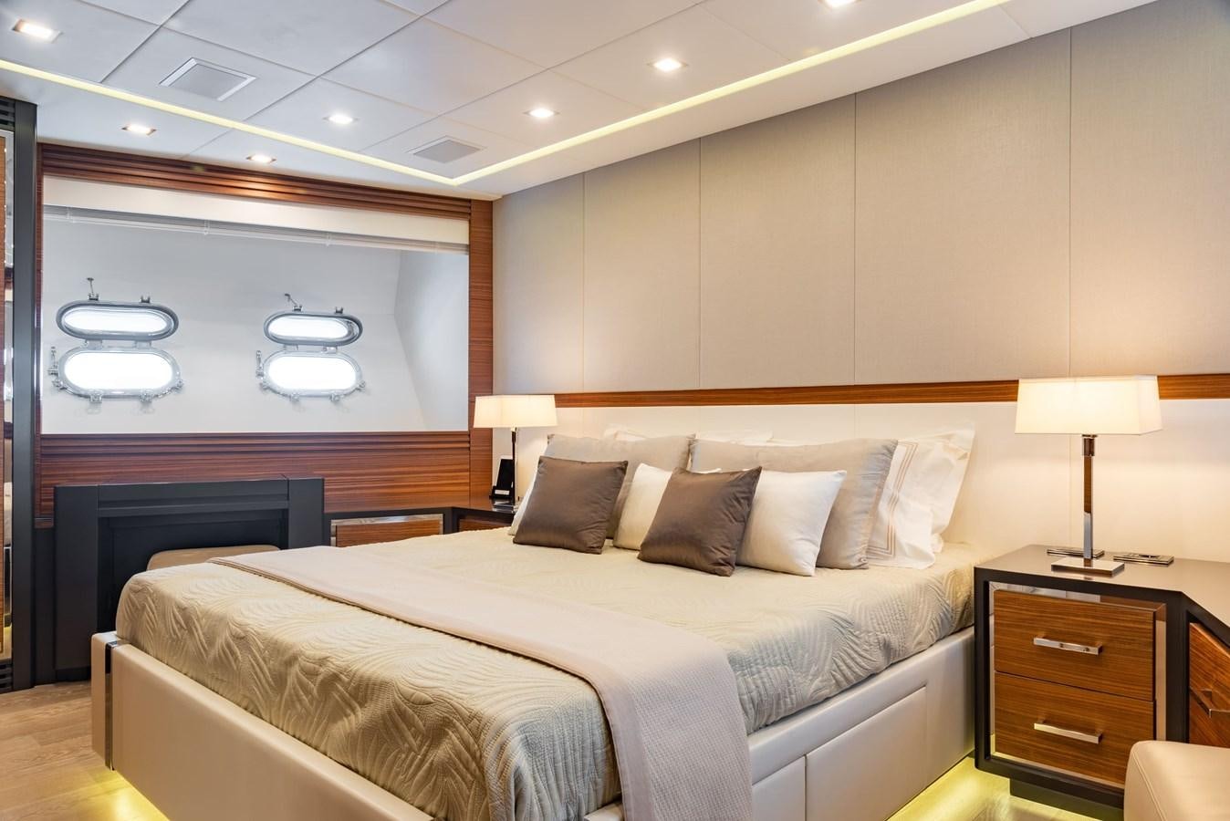 a bed with a white bed spread aboard ASYA Yacht for Sale