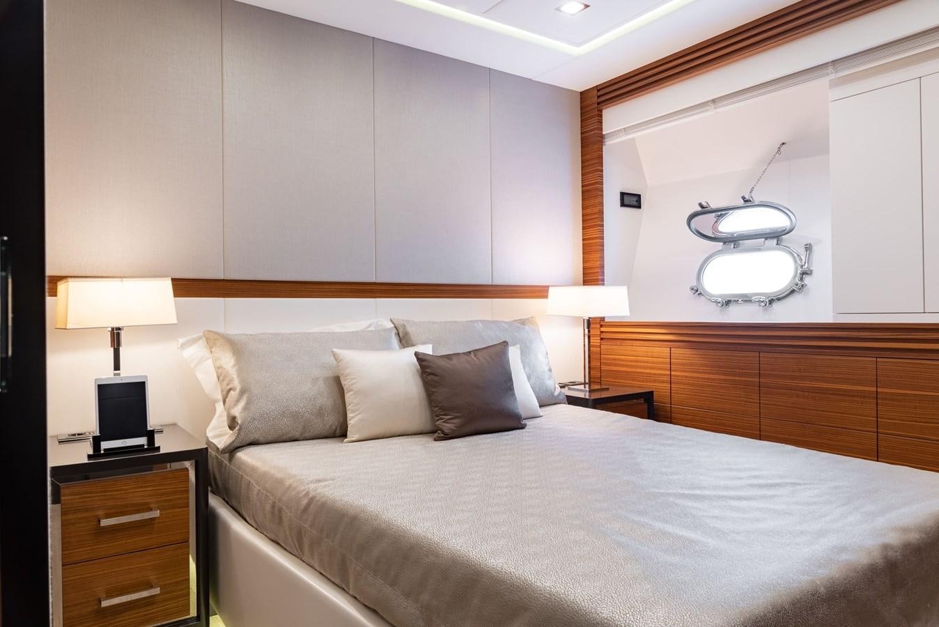 a bed with a white bed spread aboard ASYA Yacht for Sale