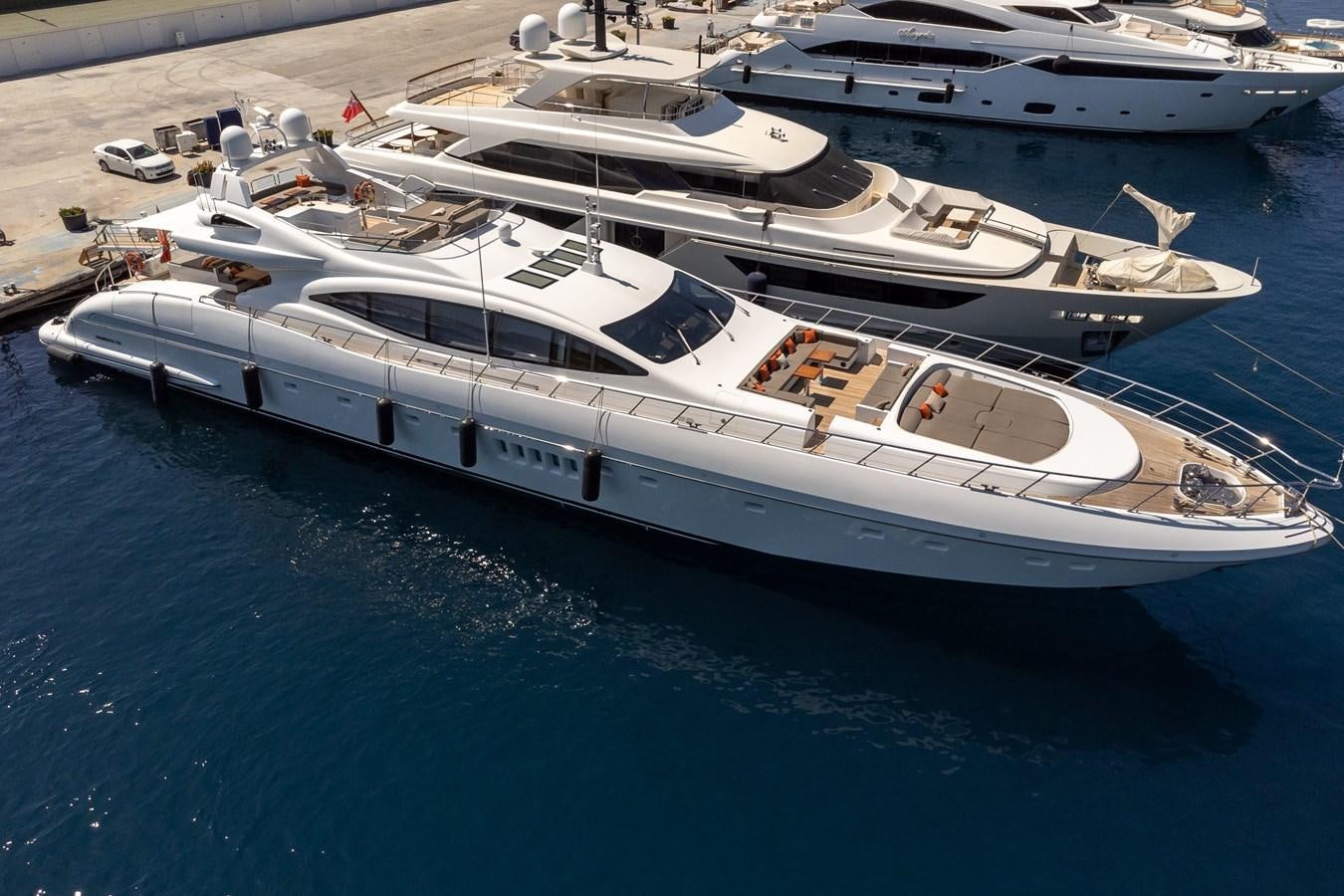 a white yacht on a blue body of water aboard ASYA Yacht for Sale