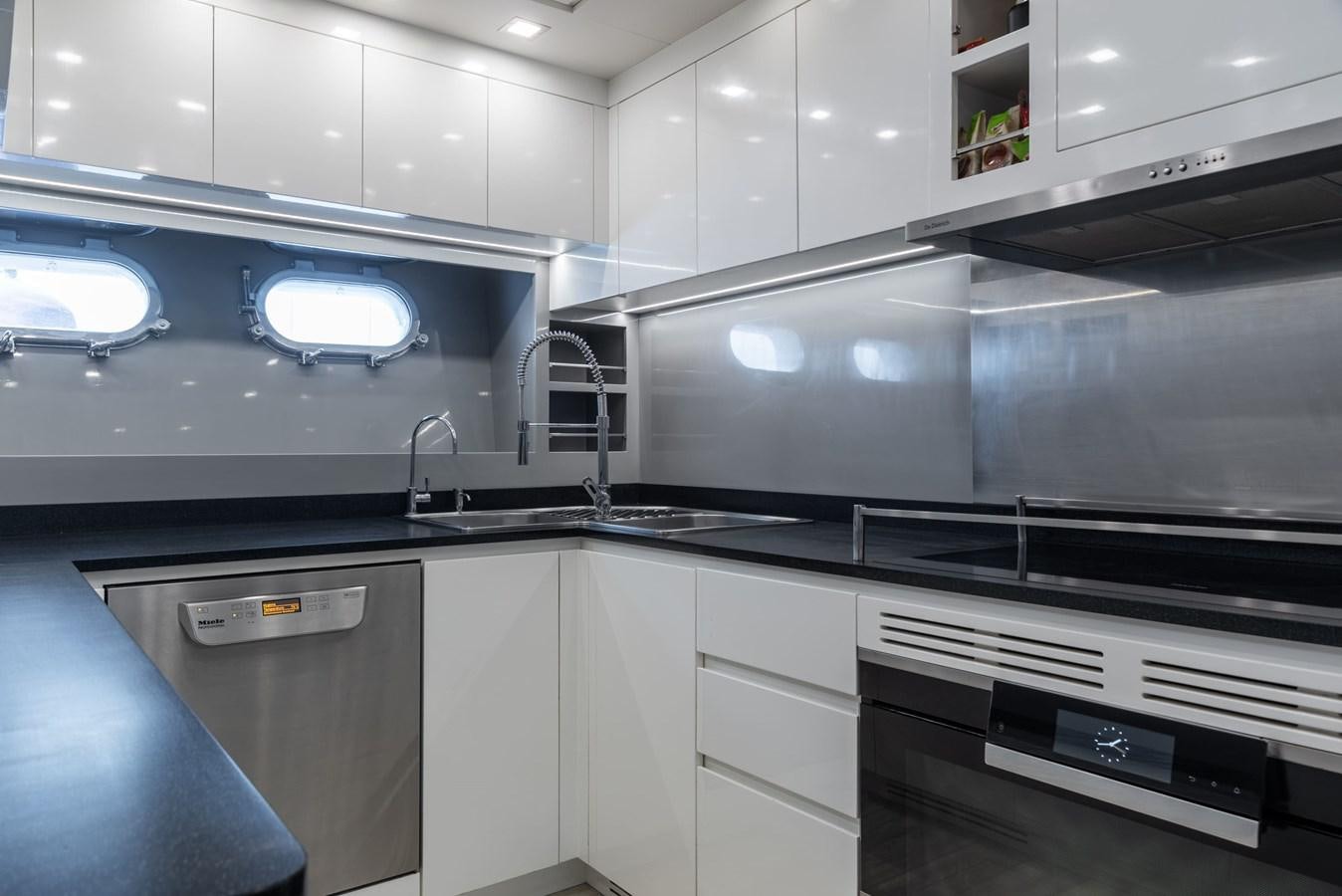 a kitchen with white cabinets aboard ASYA Yacht for Sale