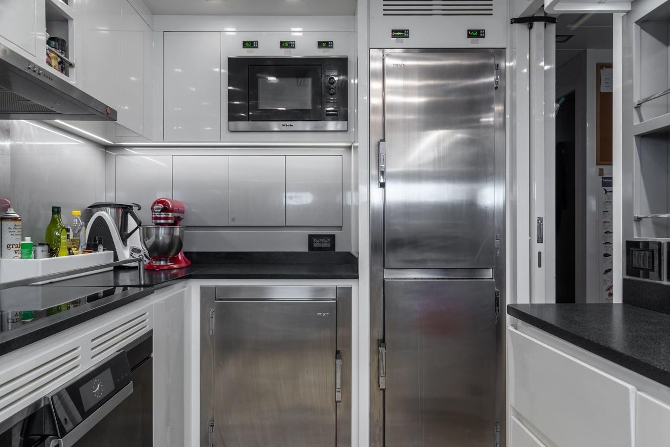 a kitchen with a stainless steel refrigerator aboard ASYA Yacht for Sale