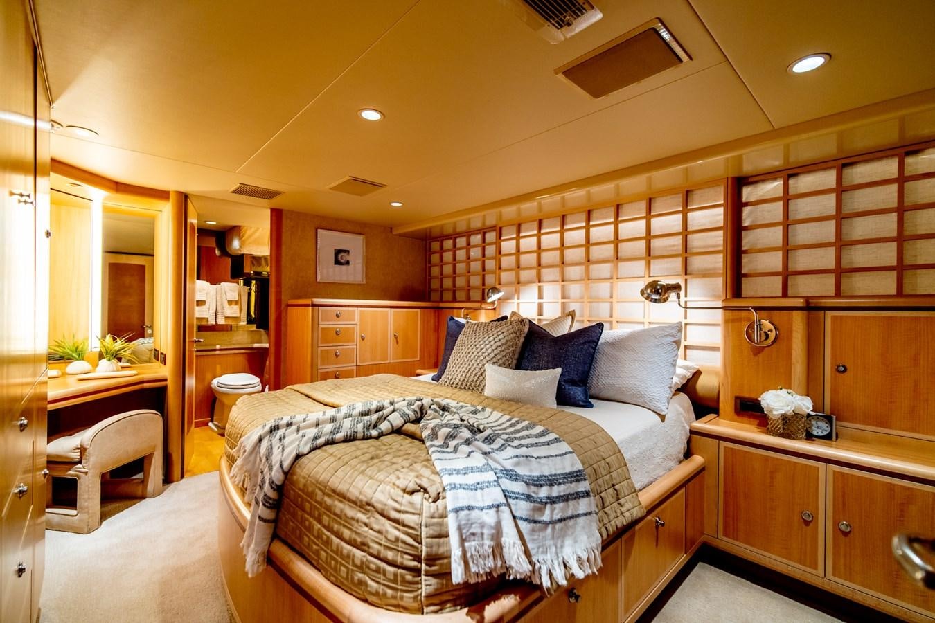 a bedroom with a bed and a mirror aboard SHADOWFAX Yacht for Sale