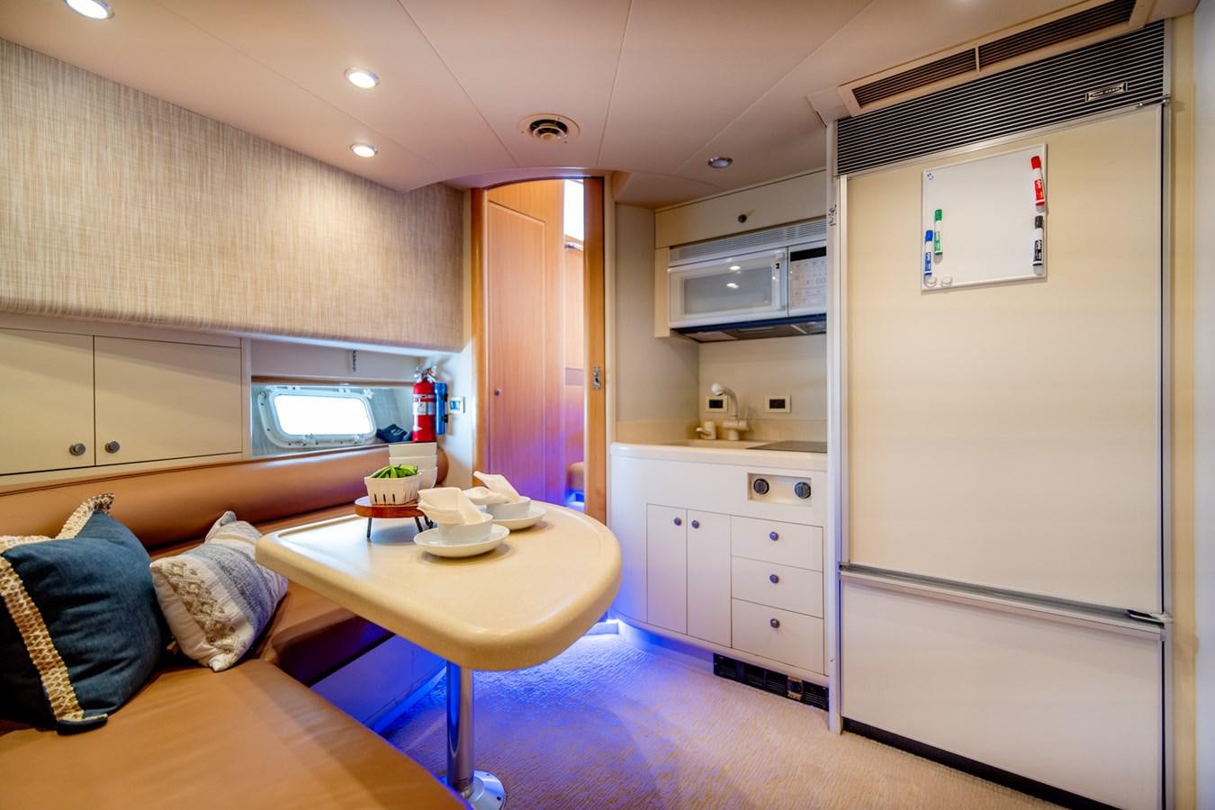 a kitchen with a table and a couch aboard SHADOWFAX Yacht for Sale