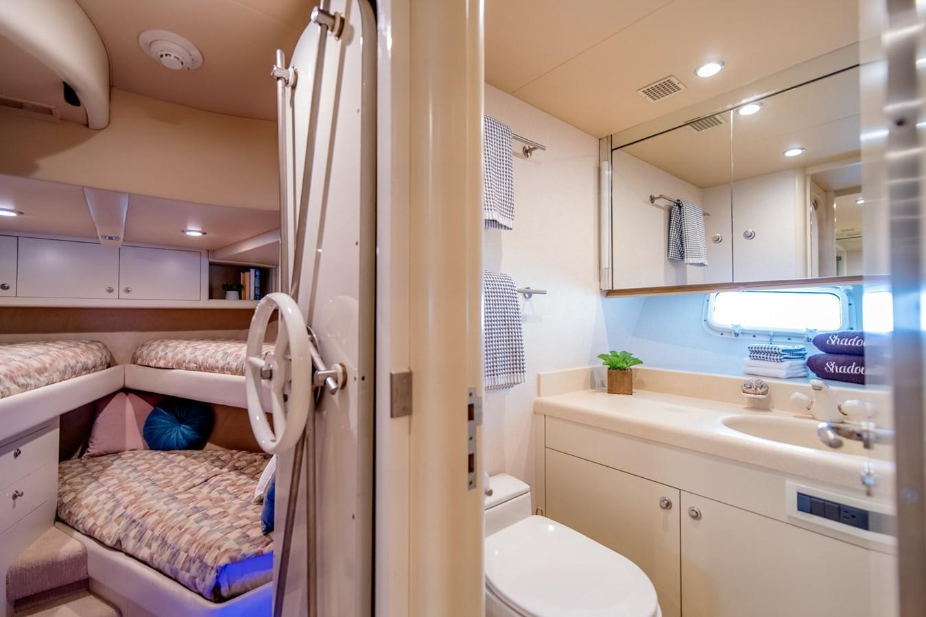a bathroom with a sink and a bed aboard SHADOWFAX Yacht for Sale