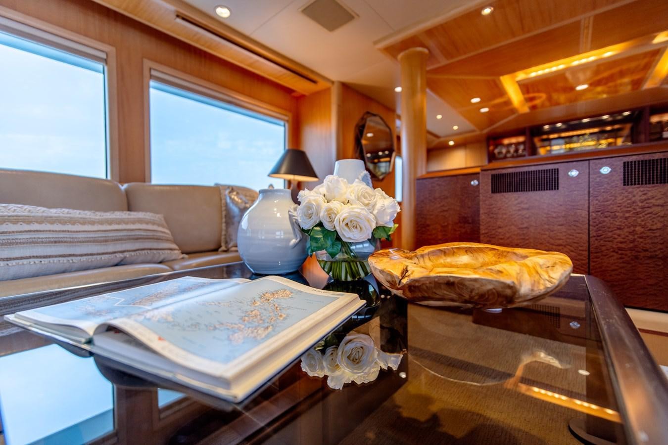 a living room with a table and couches aboard SHADOWFAX Yacht for Sale