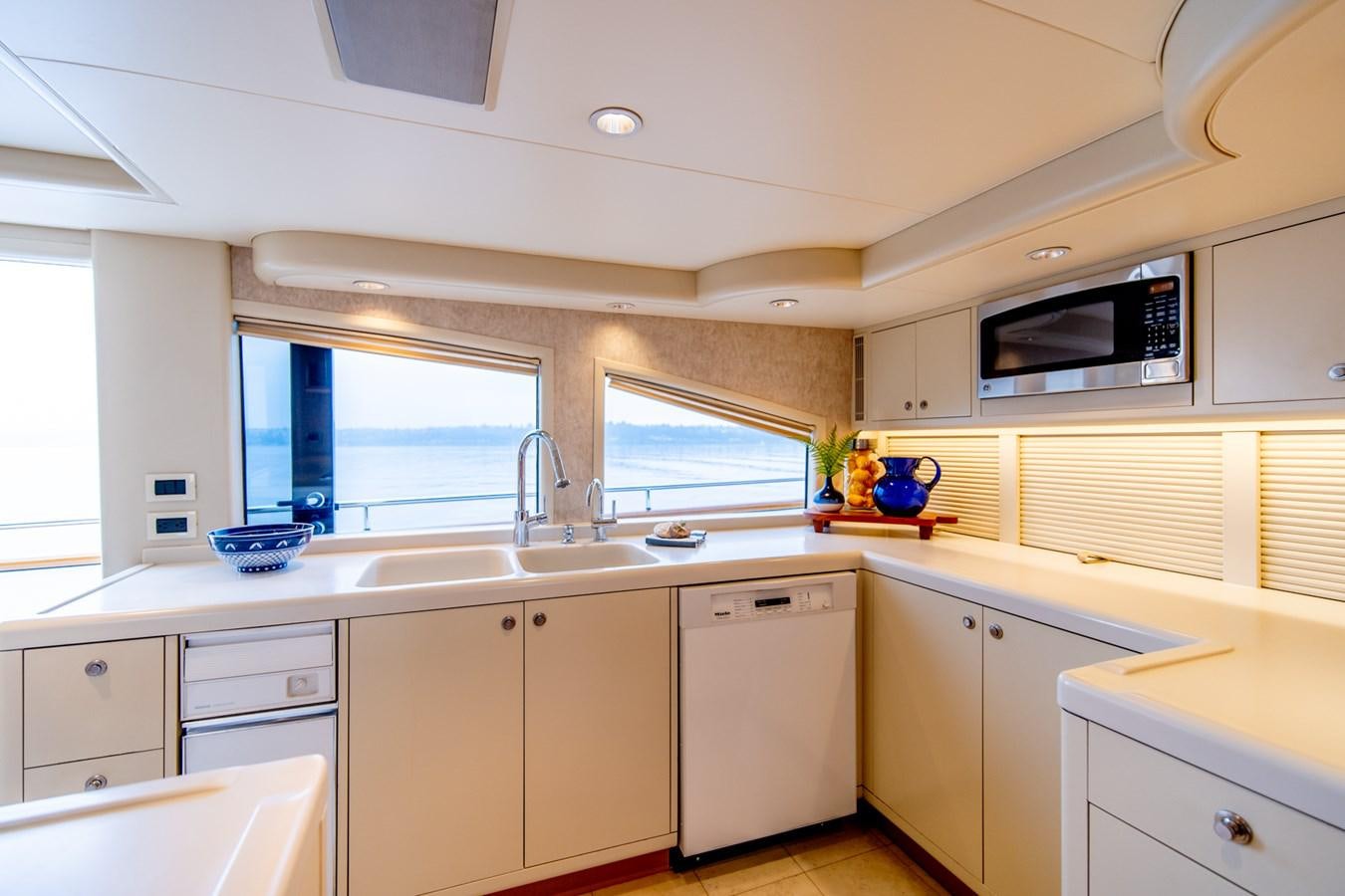 a kitchen with white cabinets aboard SHADOWFAX Yacht for Sale