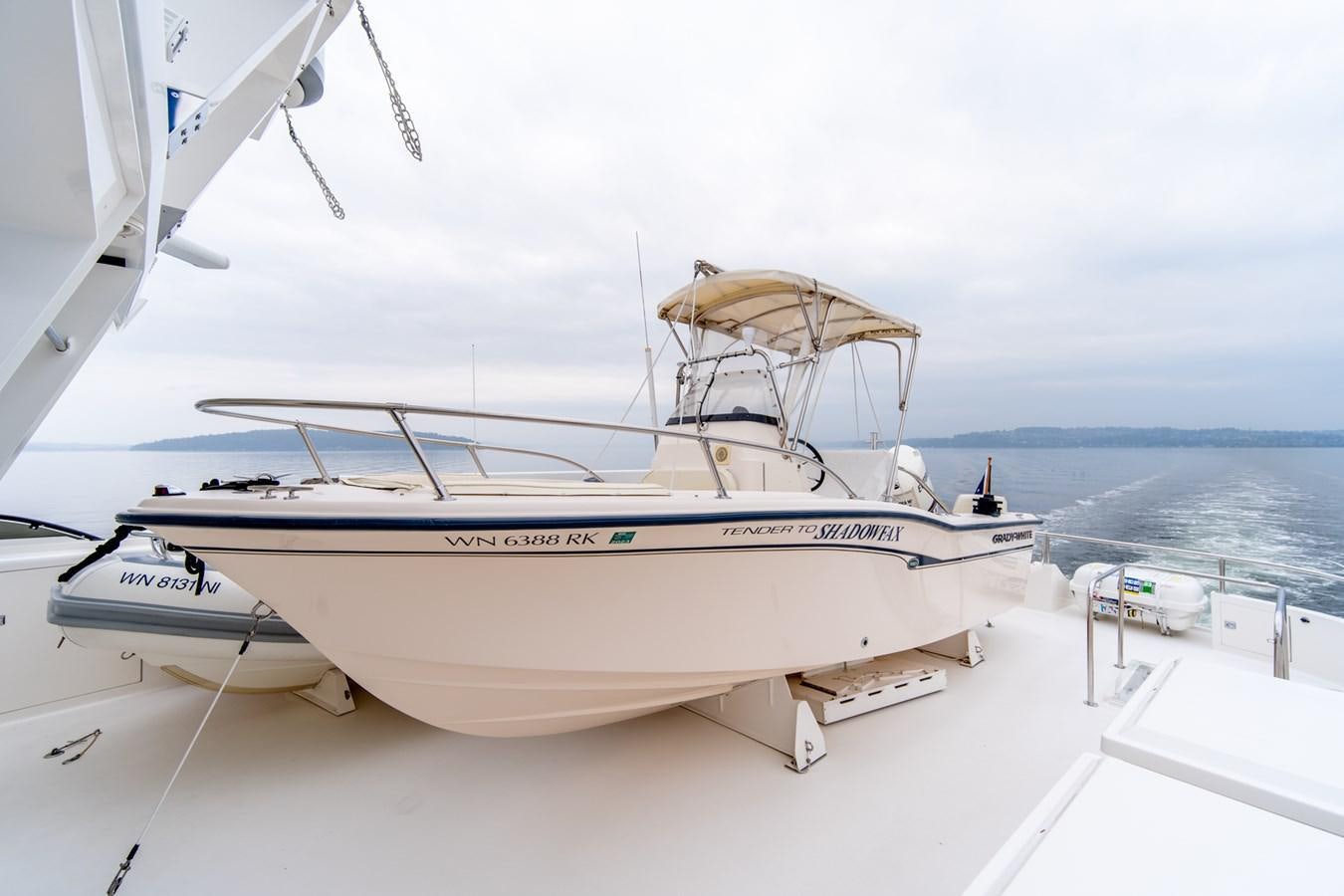 a white boat on a dock aboard SHADOWFAX Yacht for Sale