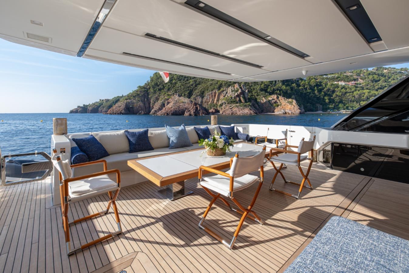 a patio with a table and chairs on it aboard MONTE-CRISTO Yacht for Sale
