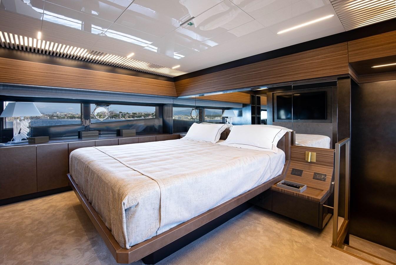 a room with a bed and a desk aboard L'OPERA Yacht for Sale