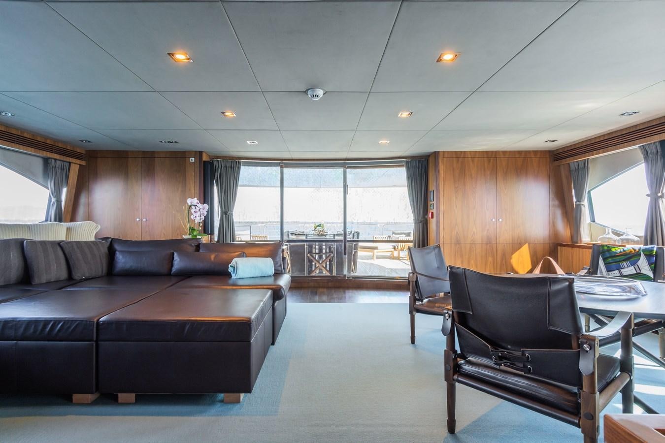 a living room with a couch and a table aboard DESEO Yacht for Sale