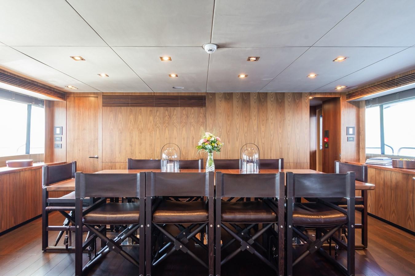 a large dining table with chairs aboard DESEO Yacht for Sale