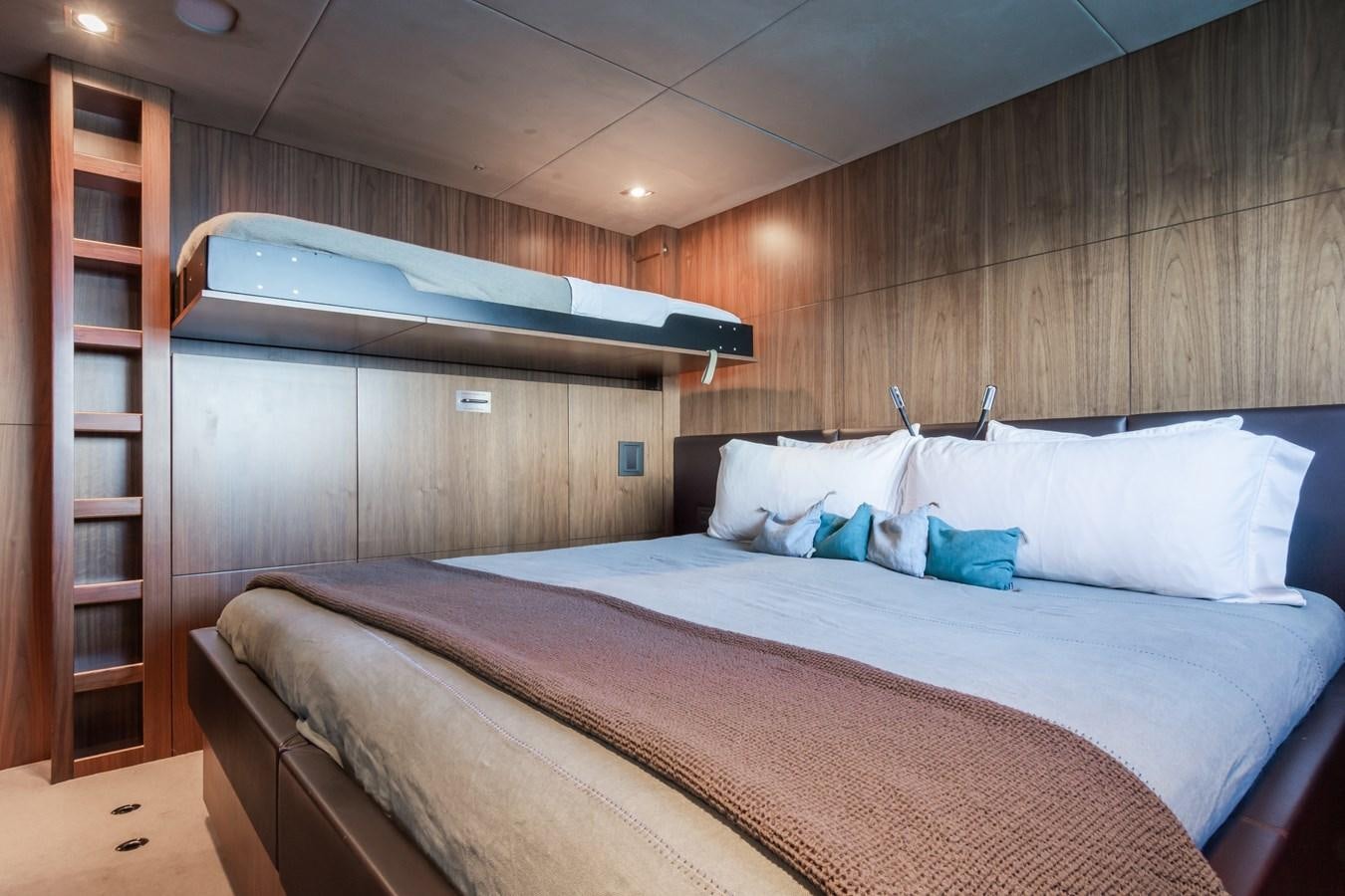 a bed with a wooden headboard aboard DESEO Yacht for Sale