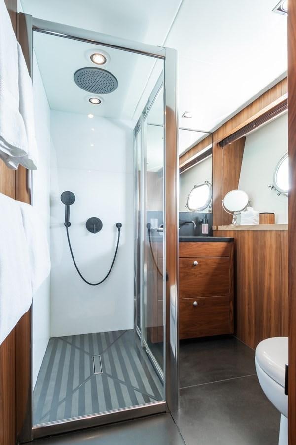 a bathroom with a shower unit aboard DESEO Yacht for Sale