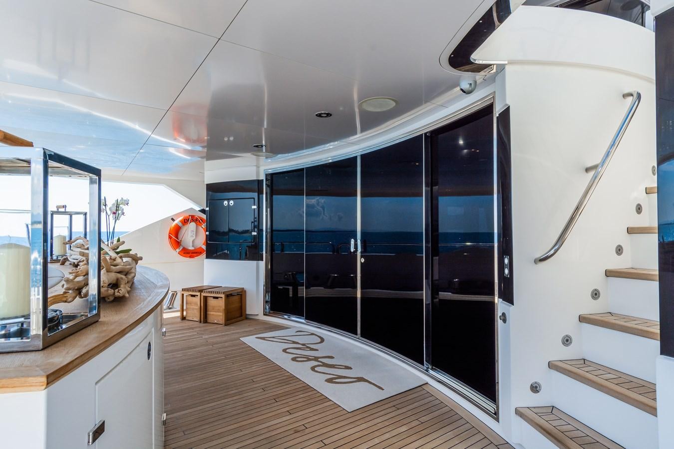 a room with a glass door and a large mirror aboard DESEO Yacht for Sale