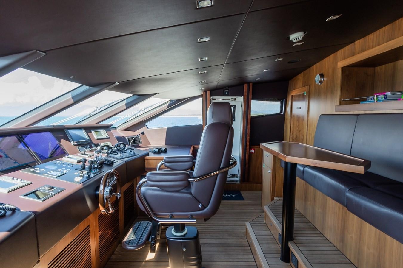 a room with a desk and chairs aboard DESEO Yacht for Sale