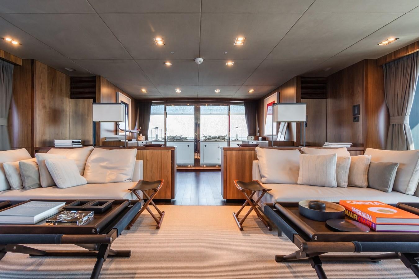 a living room with a couch and a table aboard DESEO Yacht for Sale