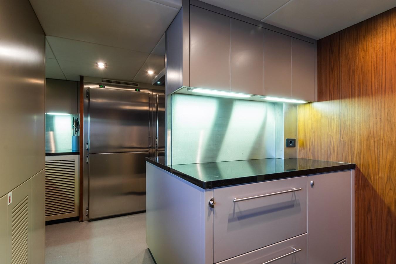 a kitchen with a refrigerator and cabinets aboard DESEO Yacht for Sale