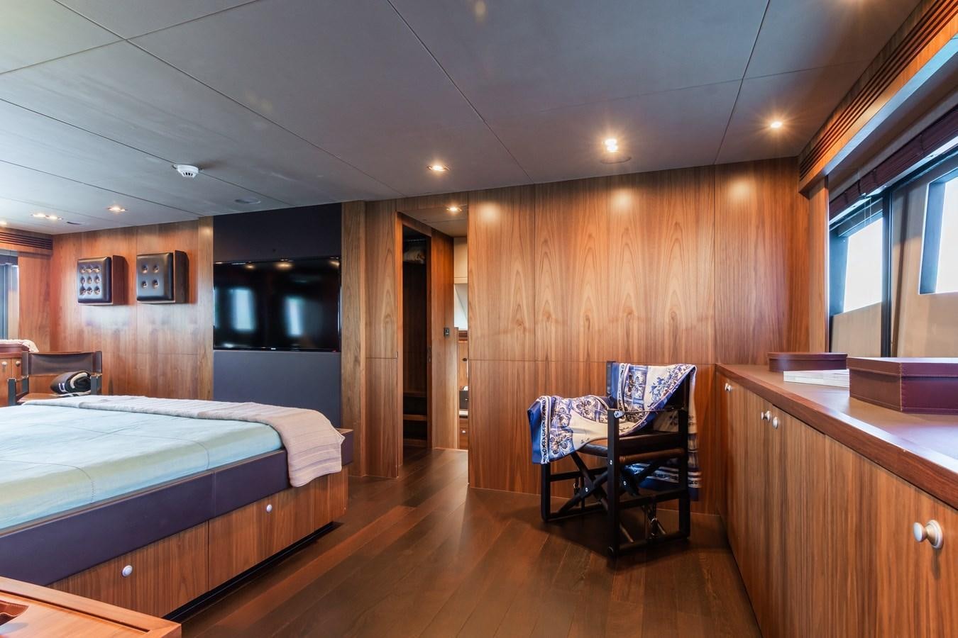 a bedroom with a wood floor aboard DESEO Yacht for Sale