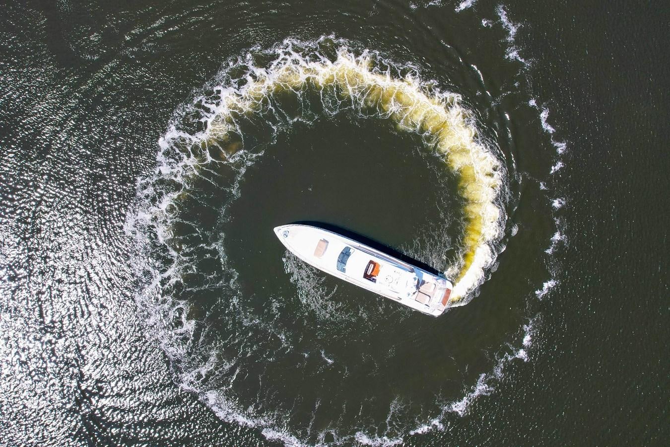 a white car on a road aboard 108' MANGUSTA 2002 Yacht for Sale