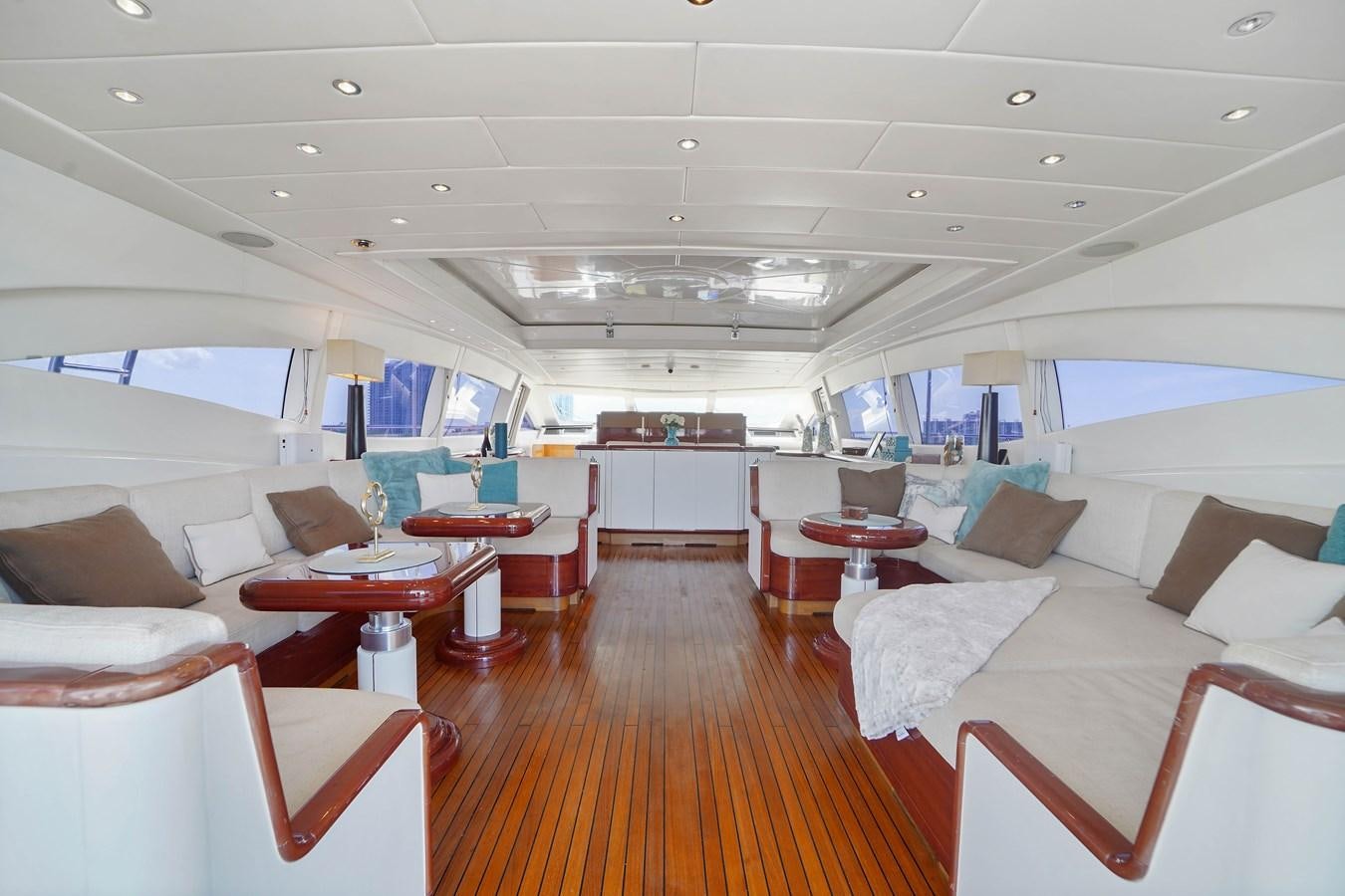 a room with a couch and a table aboard 108' MANGUSTA 2002 Yacht for Sale