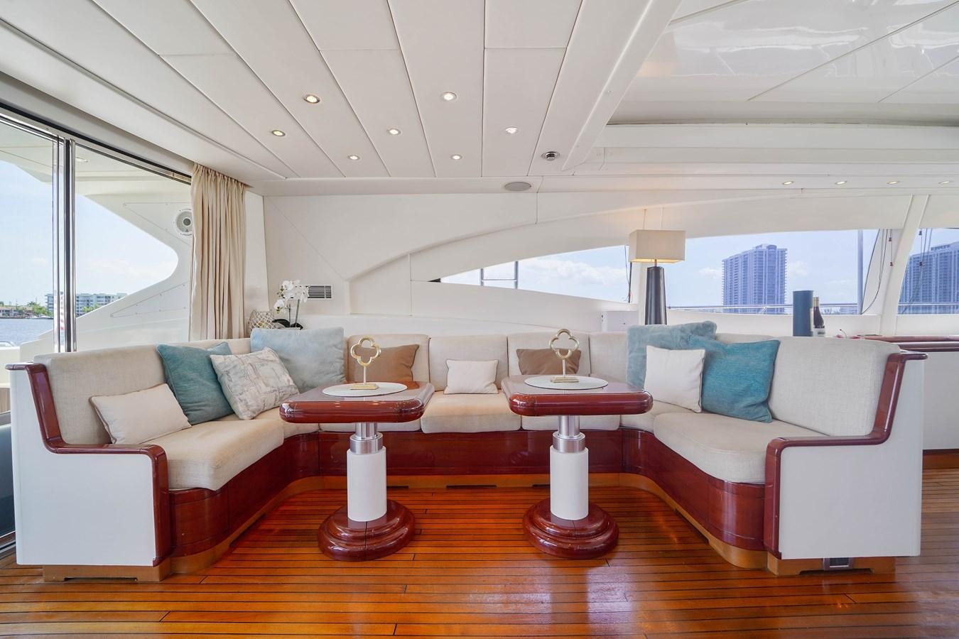 a living room with a large window aboard 108' MANGUSTA 2002 Yacht for Sale