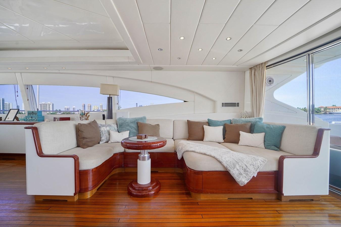 a living room with a large window aboard 108' MANGUSTA 2002 Yacht for Sale
