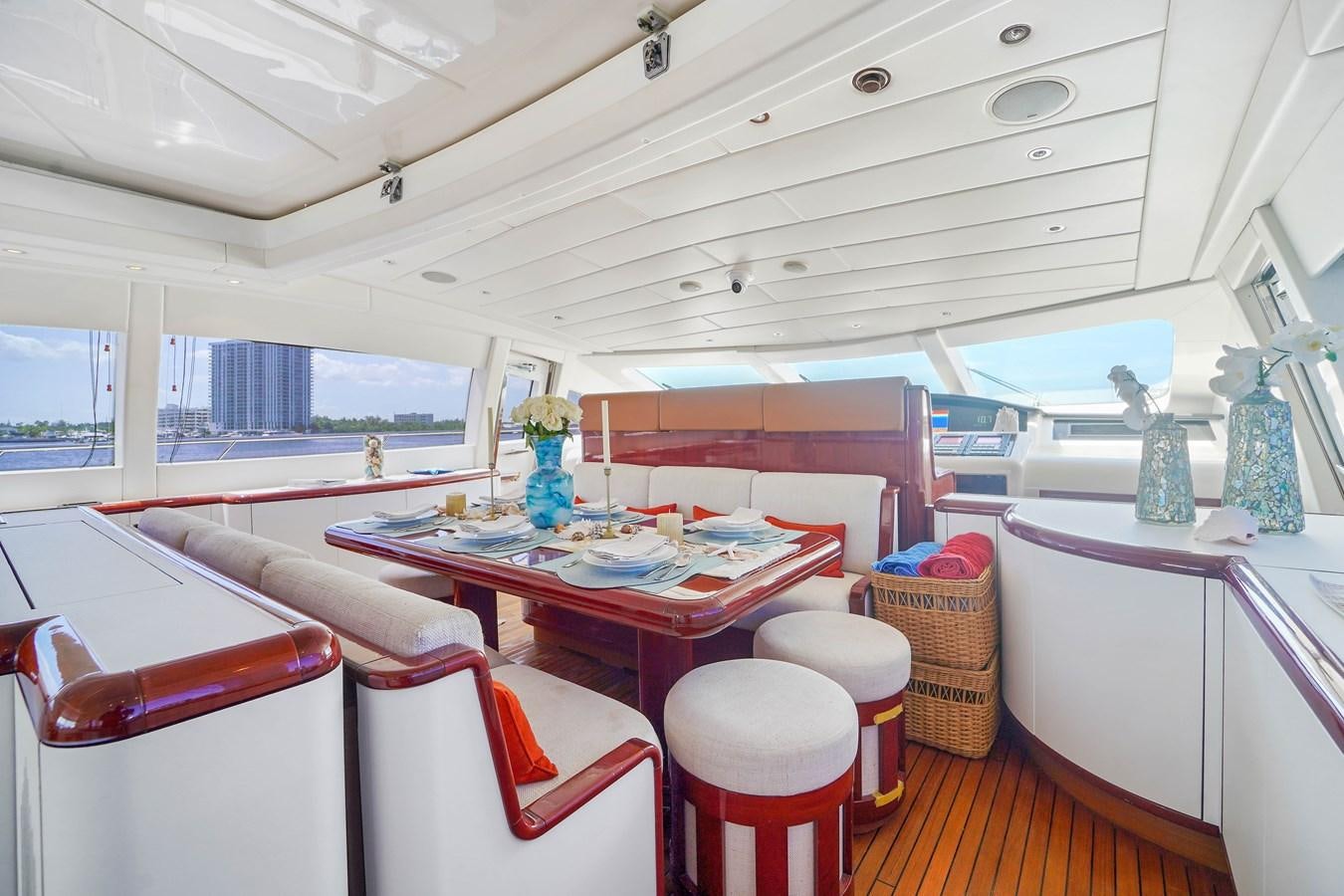 a room with pink tables and chairs aboard 108' MANGUSTA 2002 Yacht for Sale