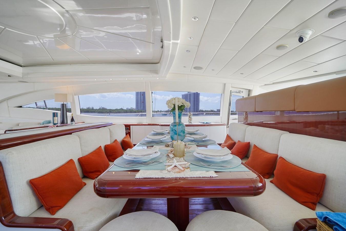 a dining room with a table and chairs aboard 108' MANGUSTA 2002 Yacht for Sale