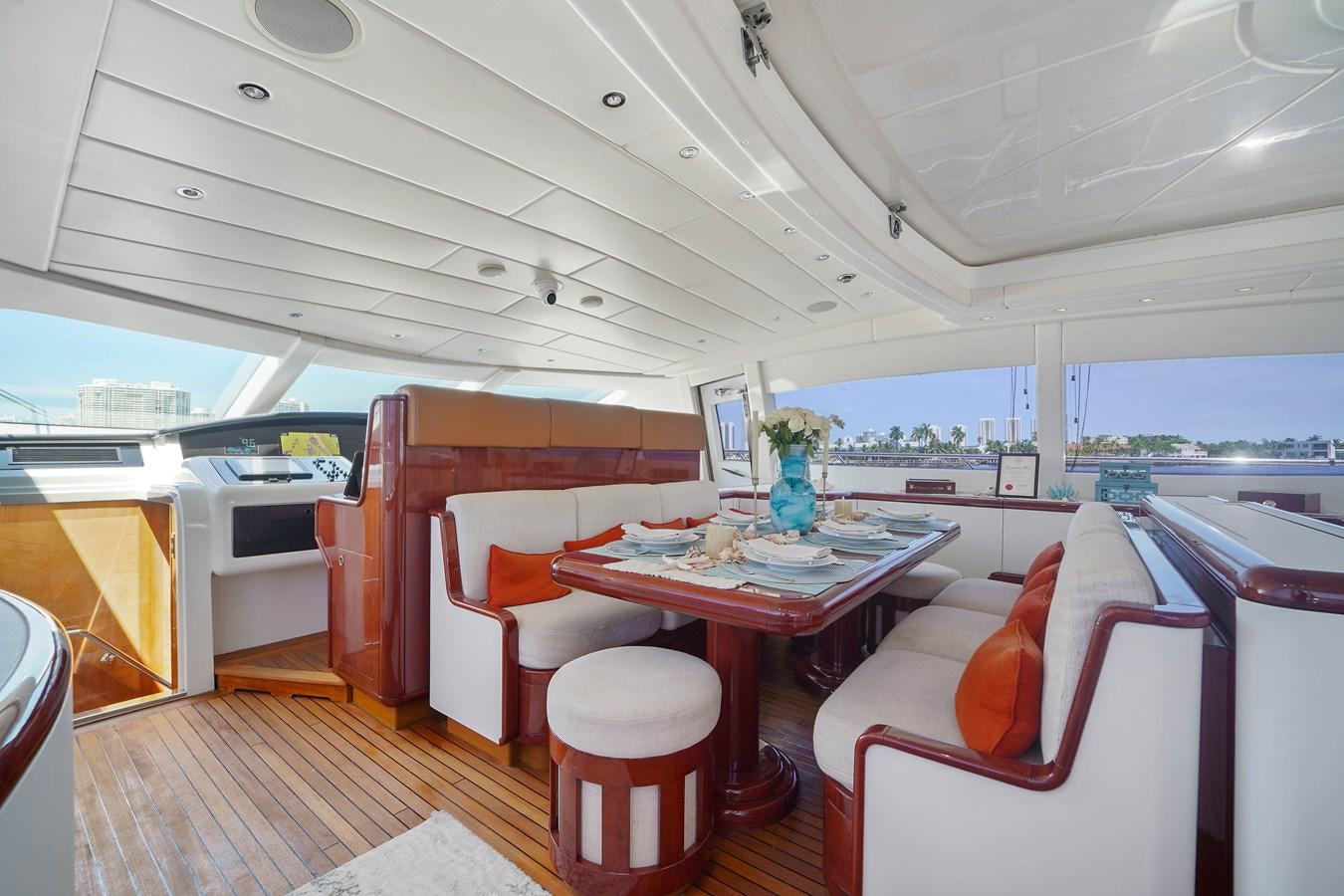a boat with a table and chairs aboard 108' MANGUSTA 2002 Yacht for Sale