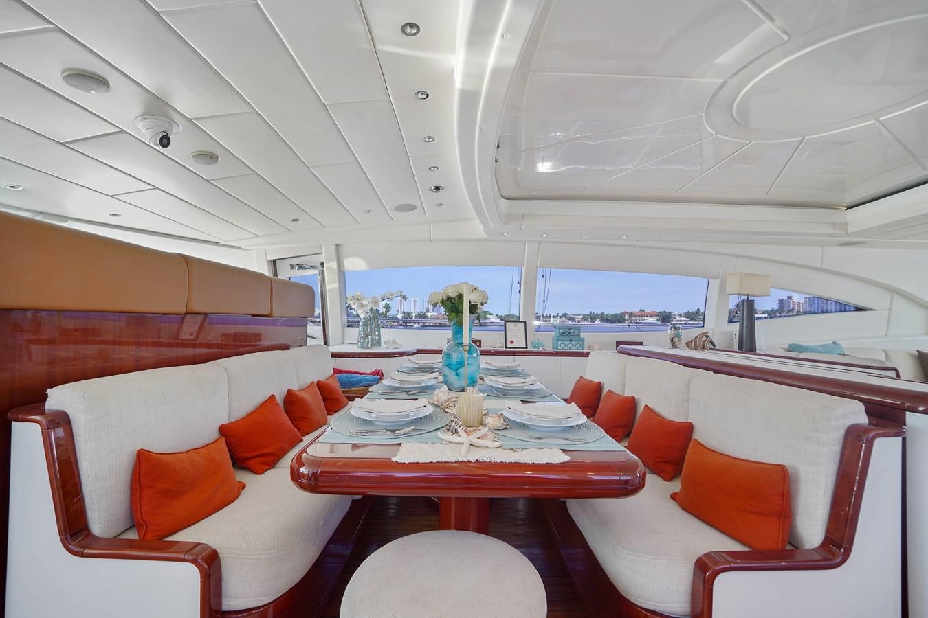 a room with a table and chairs aboard 108' MANGUSTA 2002 Yacht for Sale