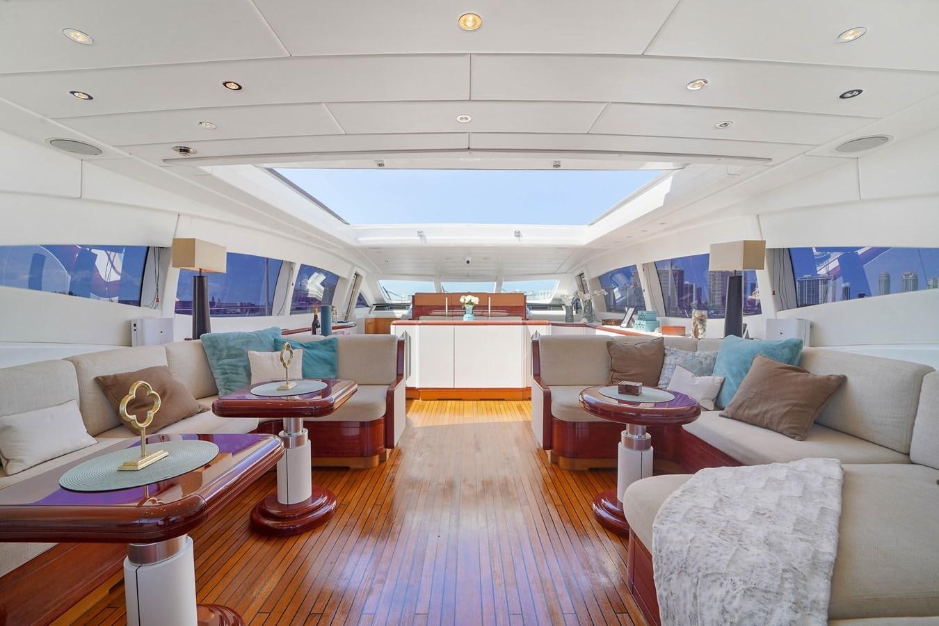 a living room with a wood floor aboard 108' MANGUSTA 2002 Yacht for Sale