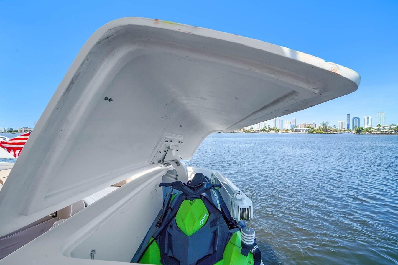 a boat with a flag on the front aboard 108' MANGUSTA 2002 Yacht for Sale