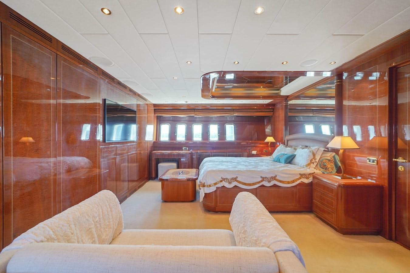 a room with a bed and a couch aboard 108' MANGUSTA 2002 Yacht for Sale