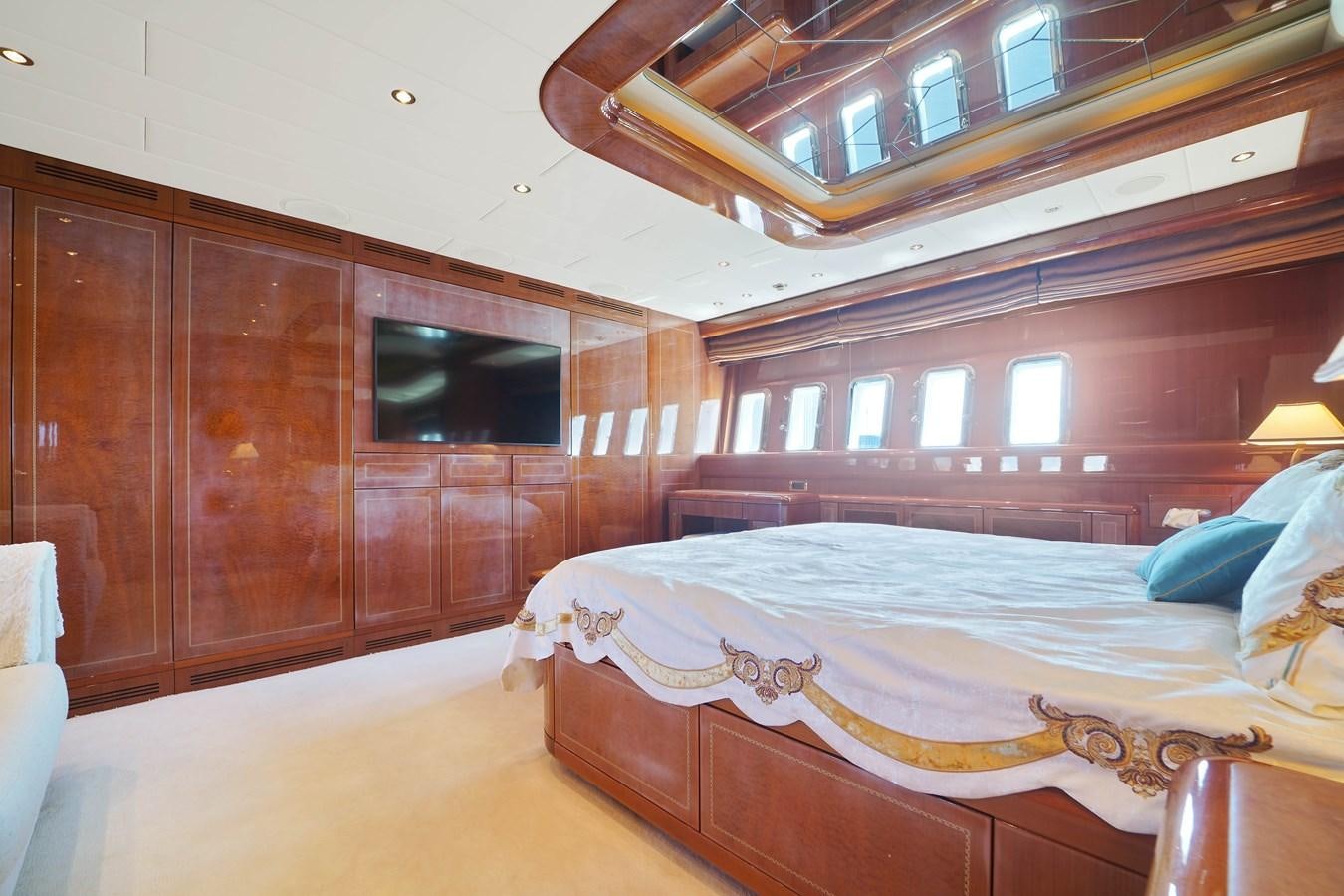 a room with a bed and a wood wall aboard 108' MANGUSTA 2002 Yacht for Sale