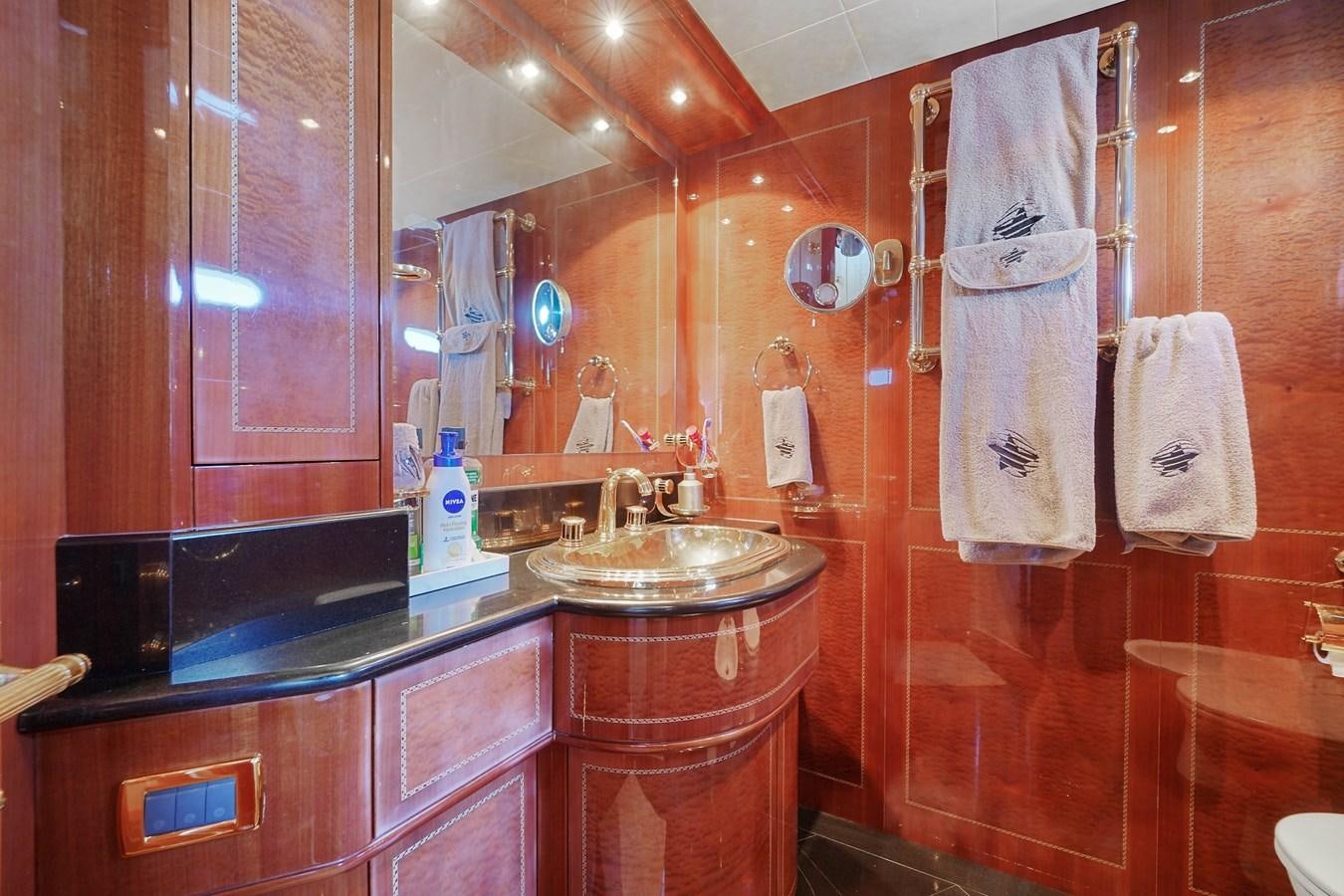 a bathroom with a sink and a mirror aboard 108' MANGUSTA 2002 Yacht for Sale