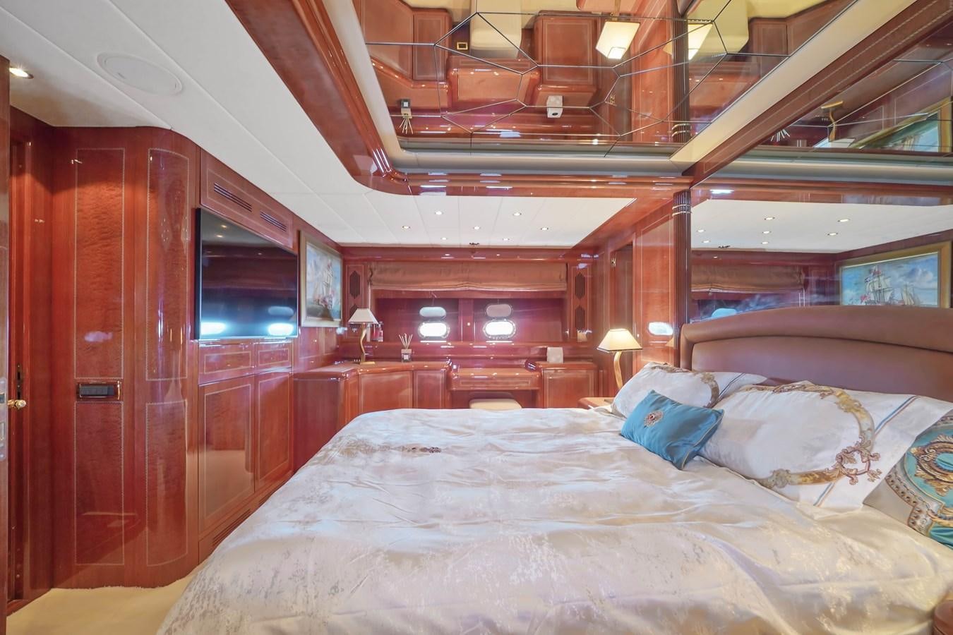 a room with a bed and a wood door aboard 108' MANGUSTA 2002 Yacht for Sale
