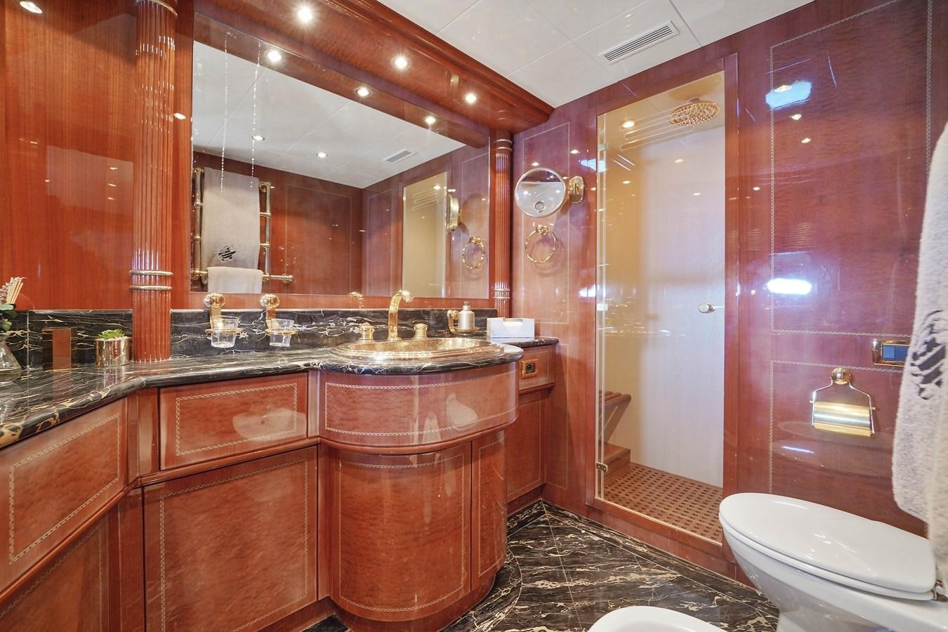 a bathroom with a large mirror aboard 108' MANGUSTA 2002 Yacht for Sale