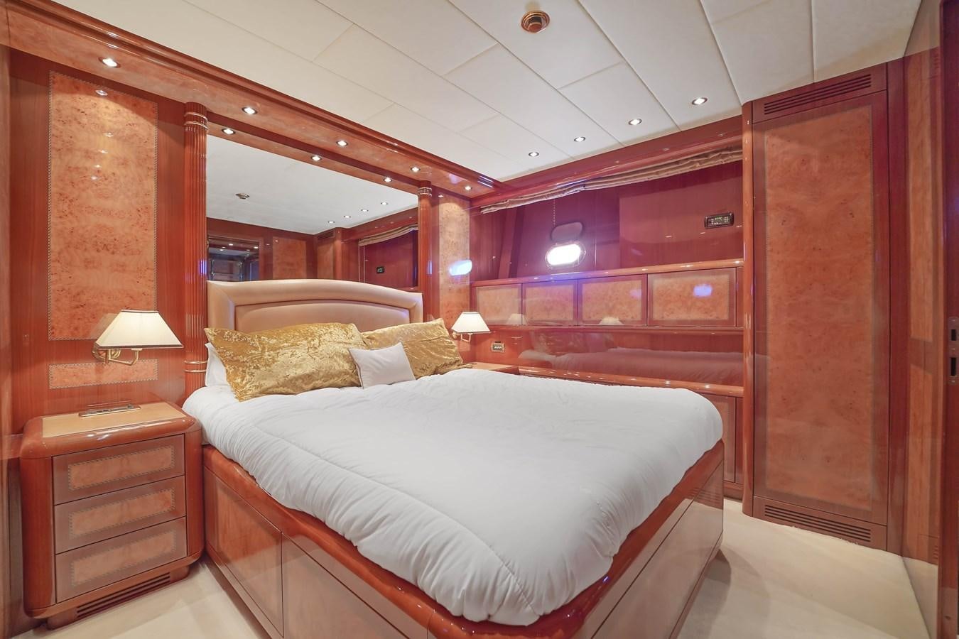 a bedroom with a bed and a mirror aboard 108' MANGUSTA 2002 Yacht for Sale