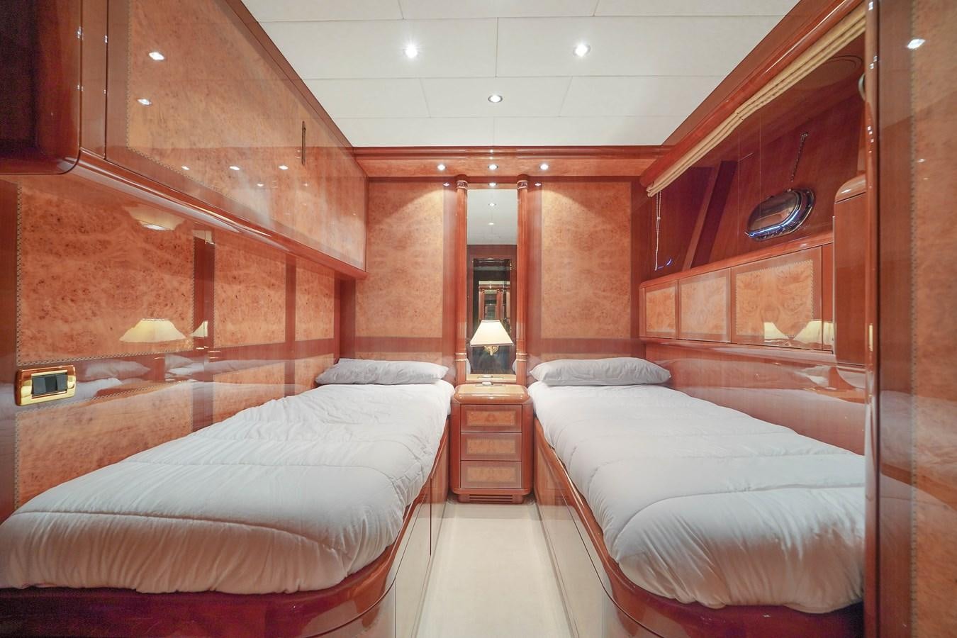 a room with two beds aboard 108' MANGUSTA 2002 Yacht for Sale
