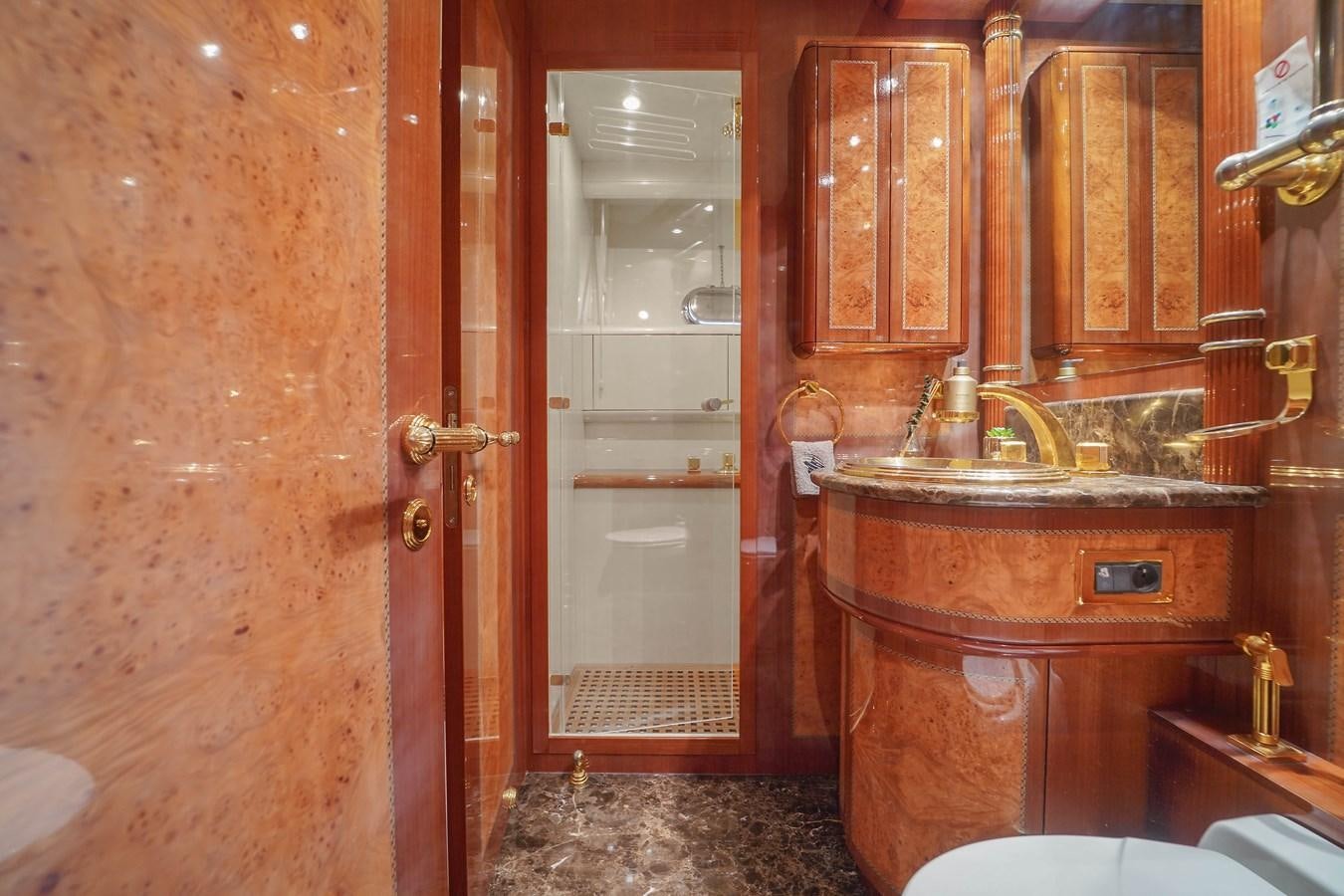 a bathroom with a sink and a toilet aboard 108' MANGUSTA 2002 Yacht for Sale