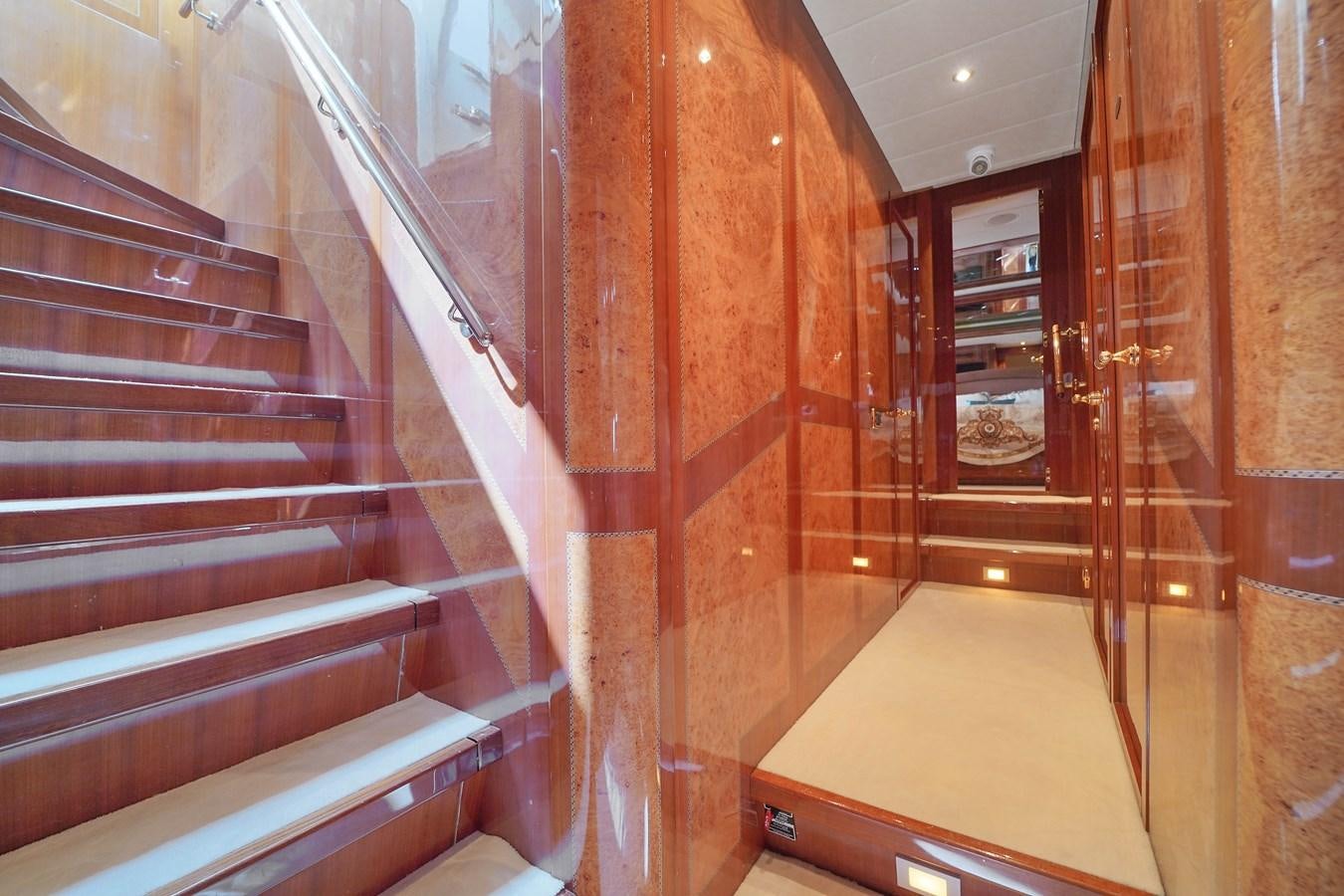 a staircase with wood walls aboard 108' MANGUSTA 2002 Yacht for Sale